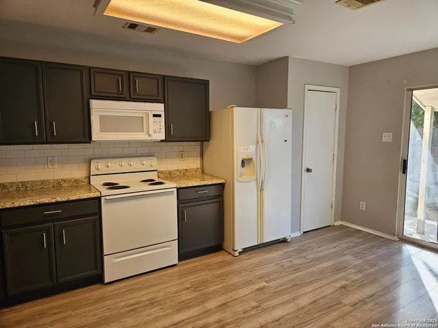 a kitchen with a refrigerator sink and stove