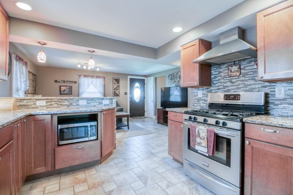146 Powell Avenue Springfield, MA 01118 - Photo 3 of 22 a kitchen with stainless steel appliances granite countertop a stove and a sink