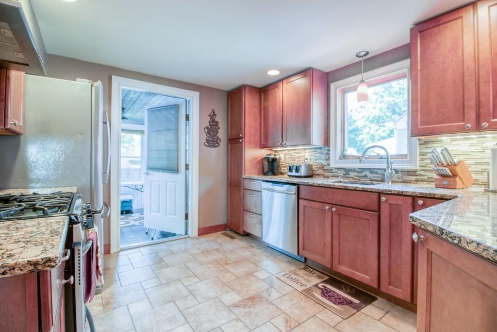 146 Powell Avenue Springfield, MA 01118 - Photo 5 of 22 a kitchen with stainless steel appliances granite countertop a stove a sink dishwasher and a refrigerator
