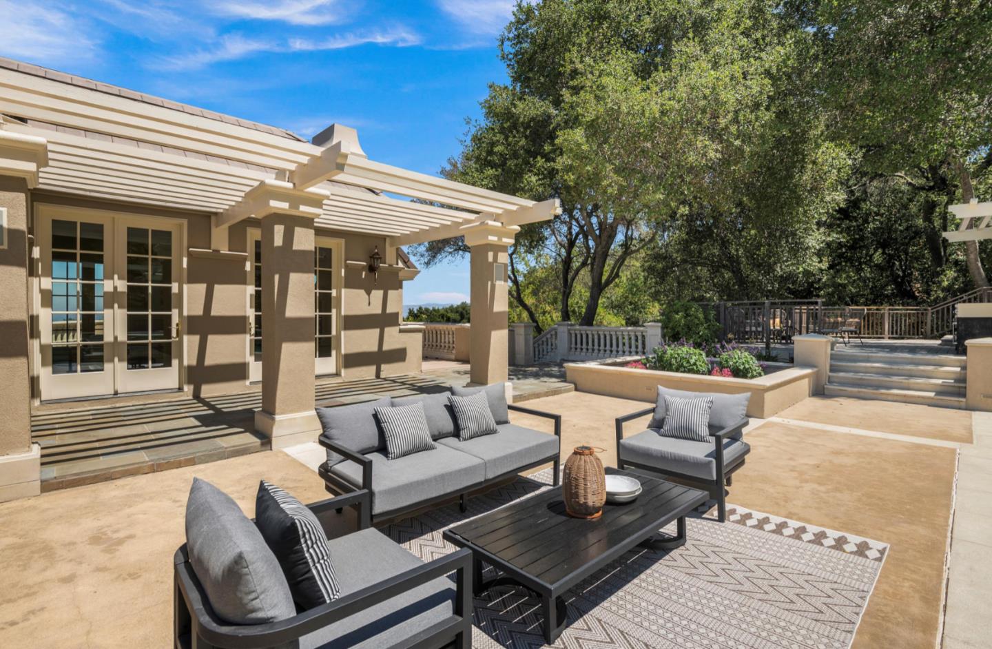 14113 Pike Road Saratoga, CA 95070 - Photo 62 of 78 a view of a patio with couches table and chairs with wooden floor and fence