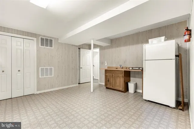 a white refrigerator freezer sitting in a kitchen