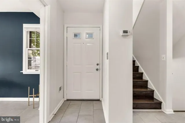 a view of a hallway with wooden floor and entryway