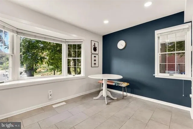 a view of a workspace with furniture and a window