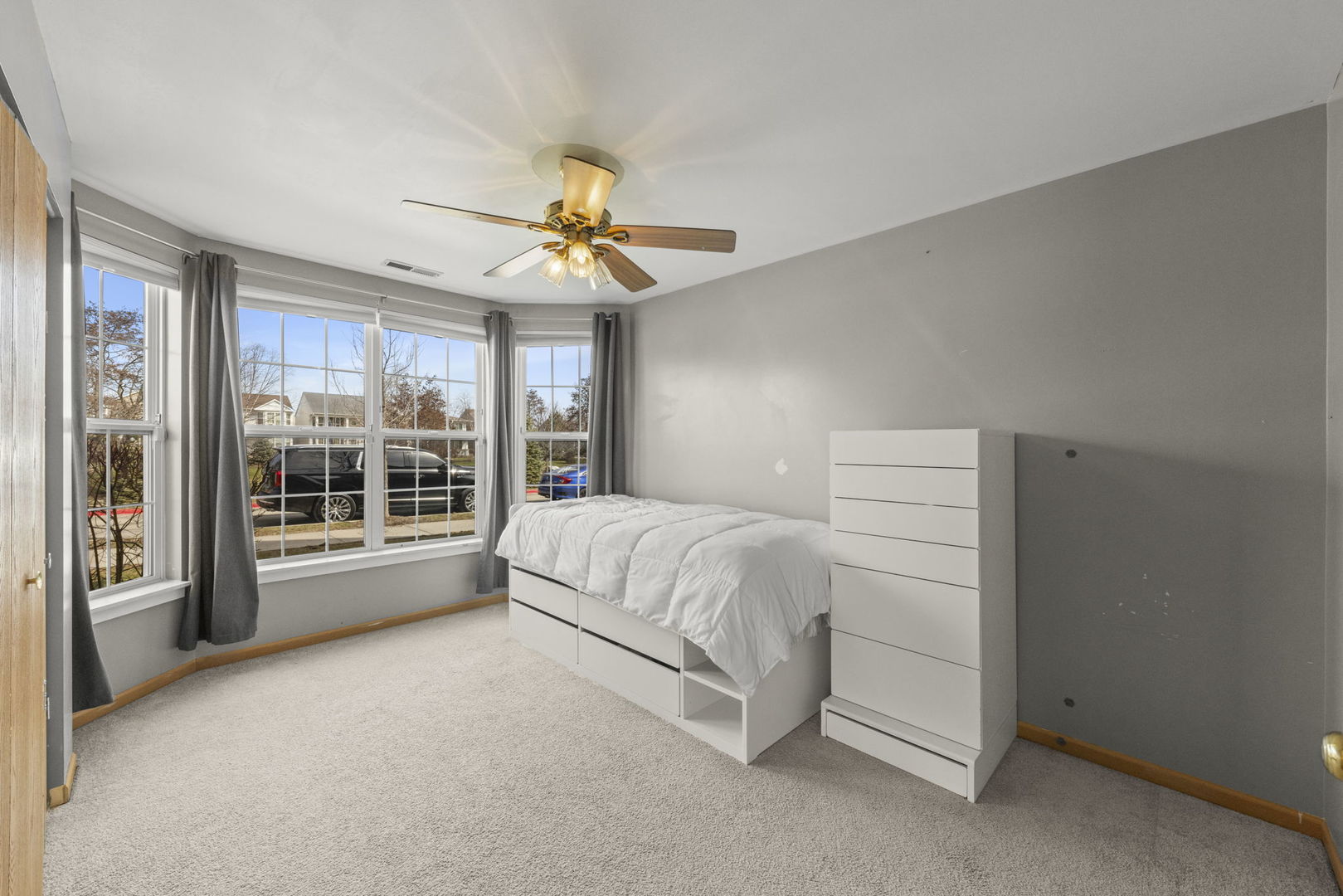 1719 Ravine Park Lane Aurora, IL 60504 - Photo 15 of 23 a spacious bedroom with a large bed and a chandelier fan