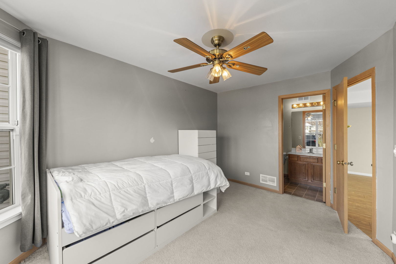 1719 Ravine Park Lane Aurora, IL 60504 - Photo 16 of 23 a bedroom with a bed and a chandelier