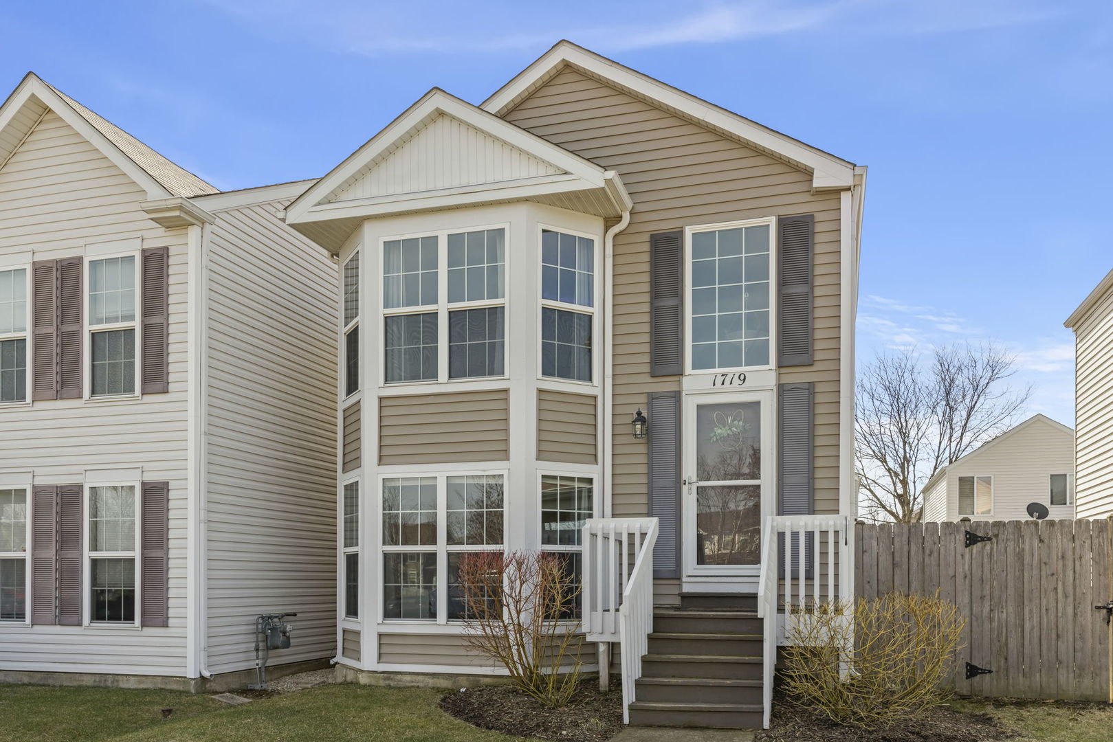 1719 Ravine Park Lane Aurora, IL 60504 - Photo 2 of 23 a front view of a house with a yard