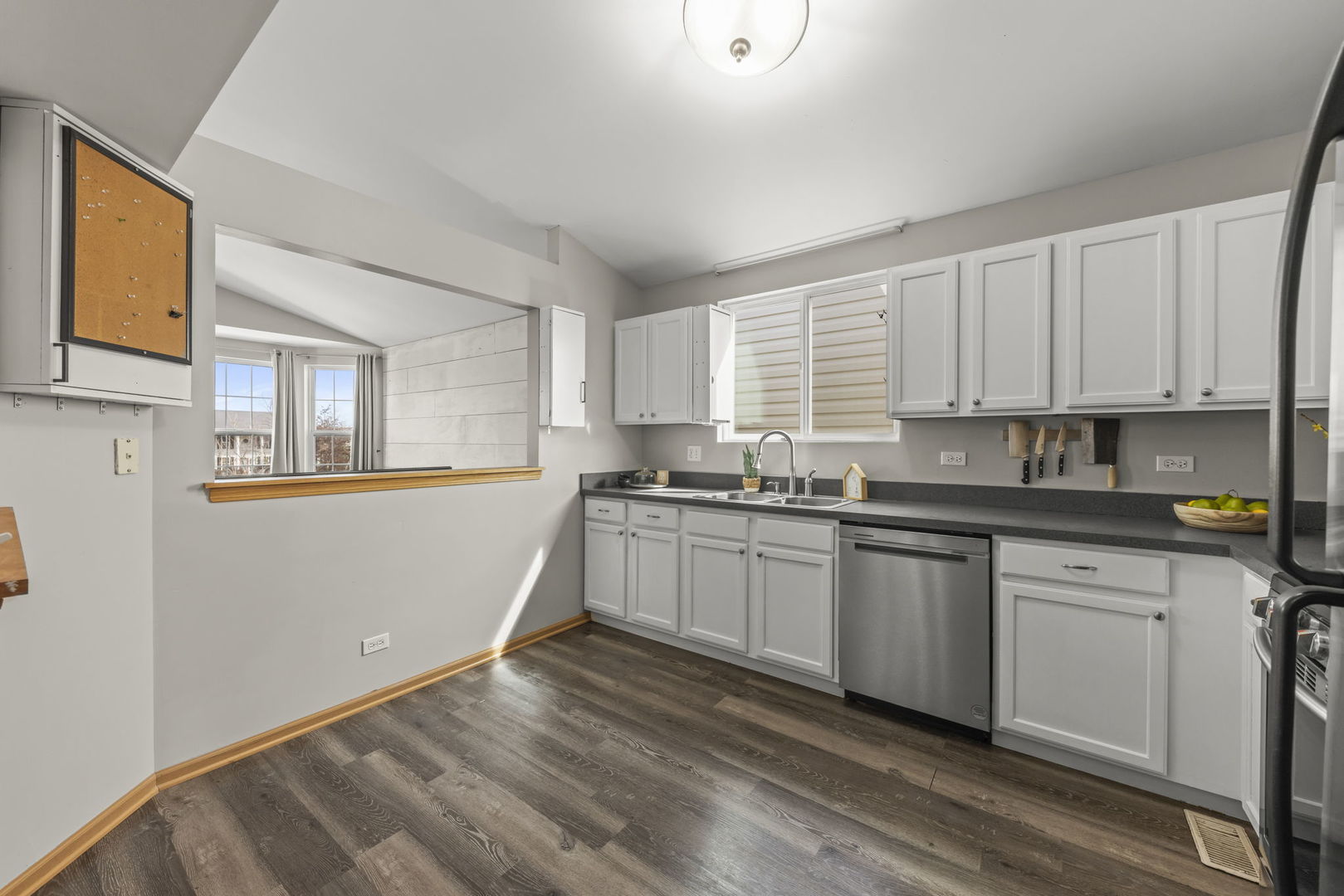 1719 Ravine Park Lane Aurora, IL 60504 - Photo 8 of 23 a kitchen with granite countertop white cabinets a sink a window and stainless steel appliances