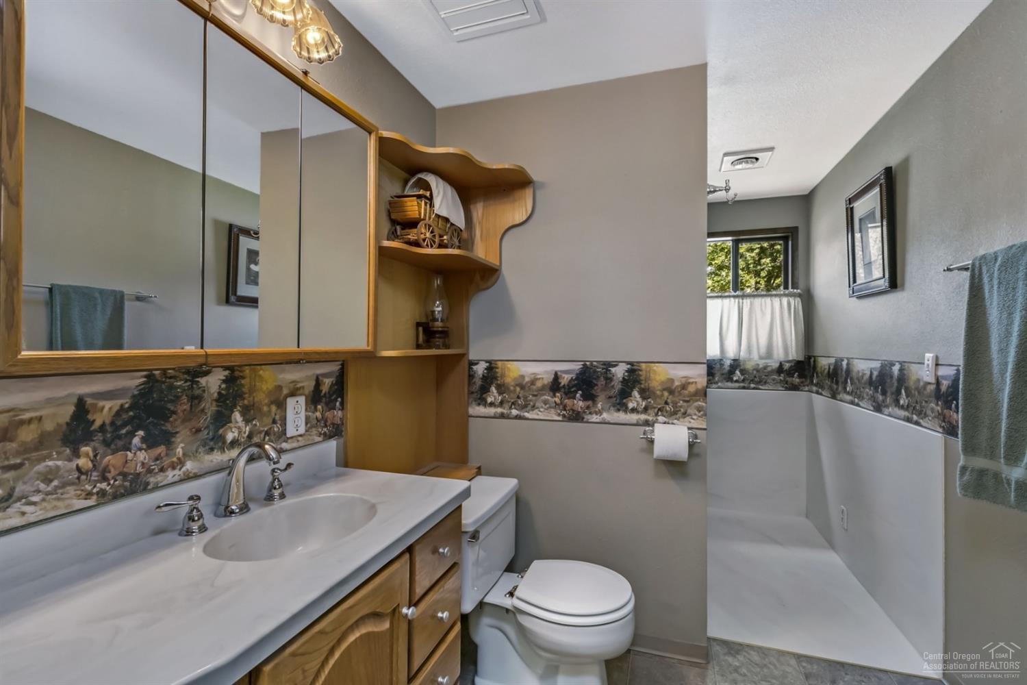 19435 Dayton Road Bend, OR 97703 - Photo 12 of 25 a bathroom with a sink toilet and mirror