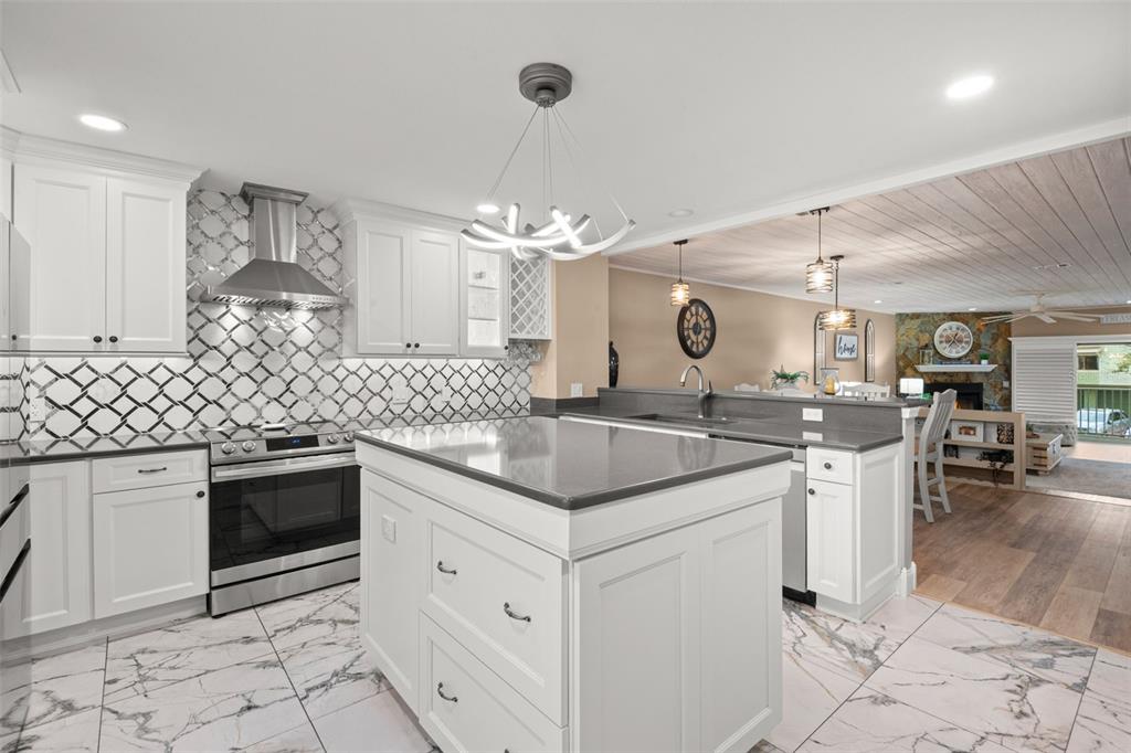 529 Sandy Hook Road Treasure Island, FL 33706 - Photo 16 of 55 a kitchen with stainless steel appliances granite countertop a sink and cabinets
