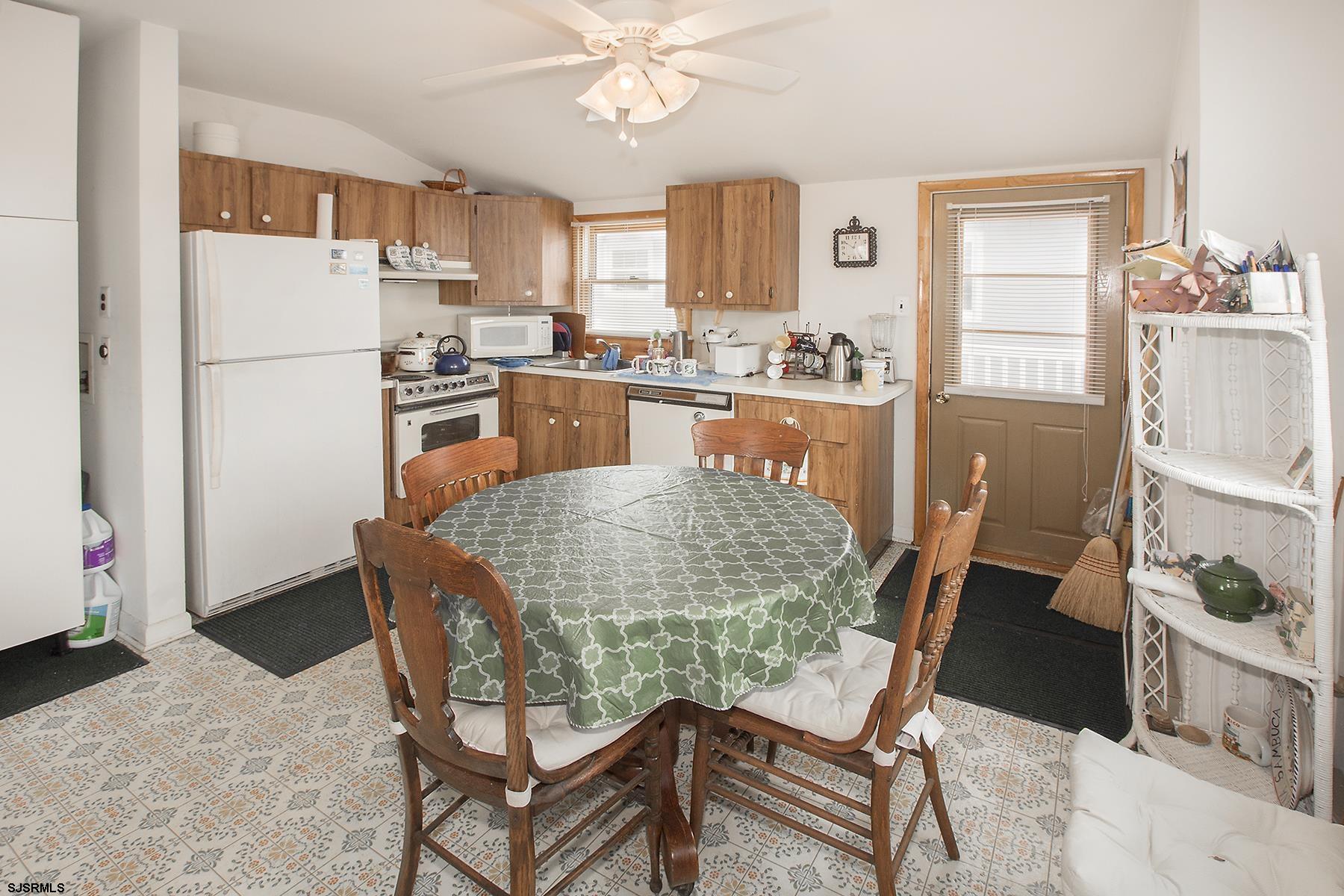 4010 West Brigantine Avenue Brigantine, NJ 08203 - Photo 3 of 10 a kitchen with stainless steel appliances granite countertop a refrigerator a stove a sink dishwasher and white cabinets with wooden floor