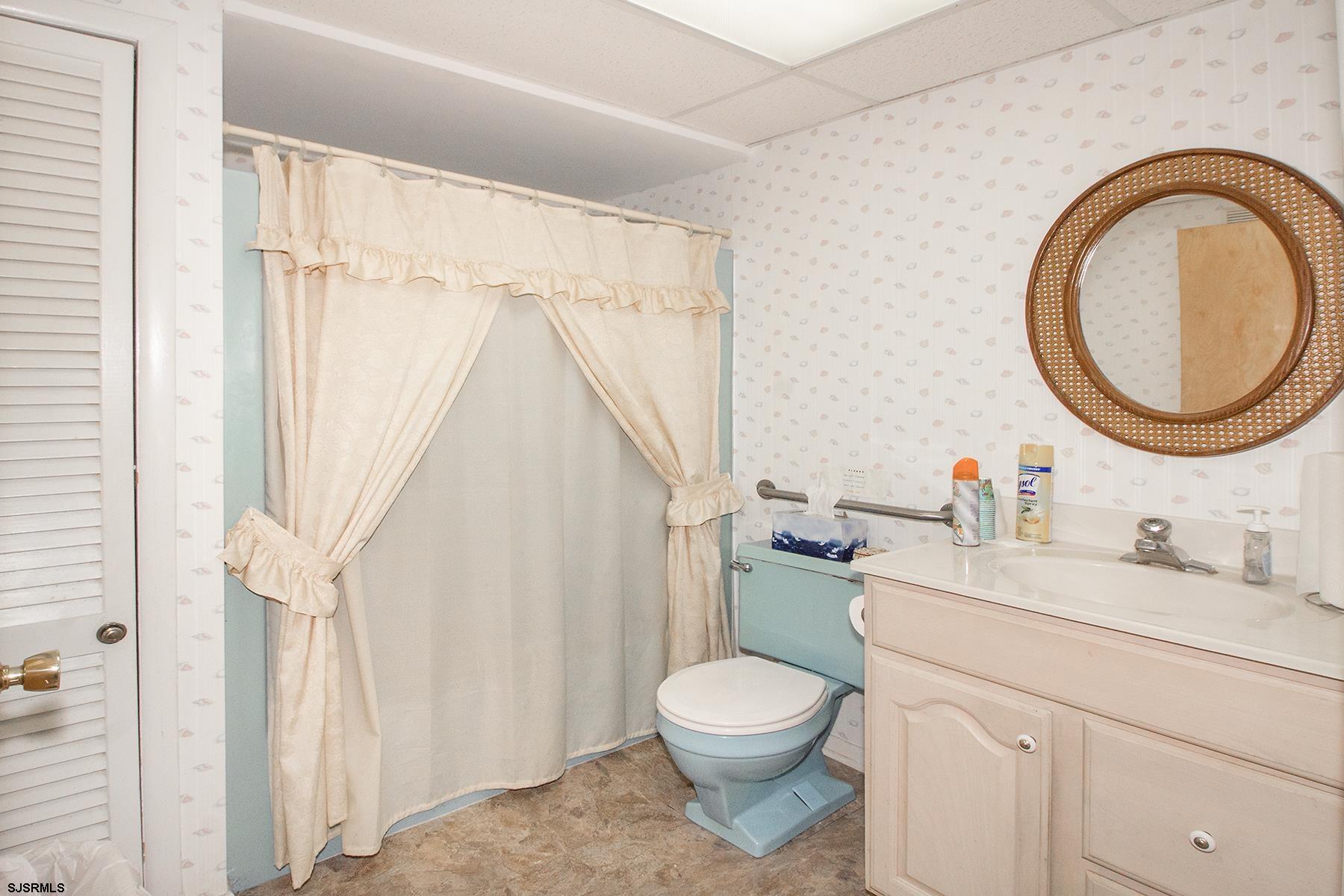 4010 West Brigantine Avenue Brigantine, NJ 08203 - Photo 10 of 10 a bathroom with a toilet a sink and a mirror