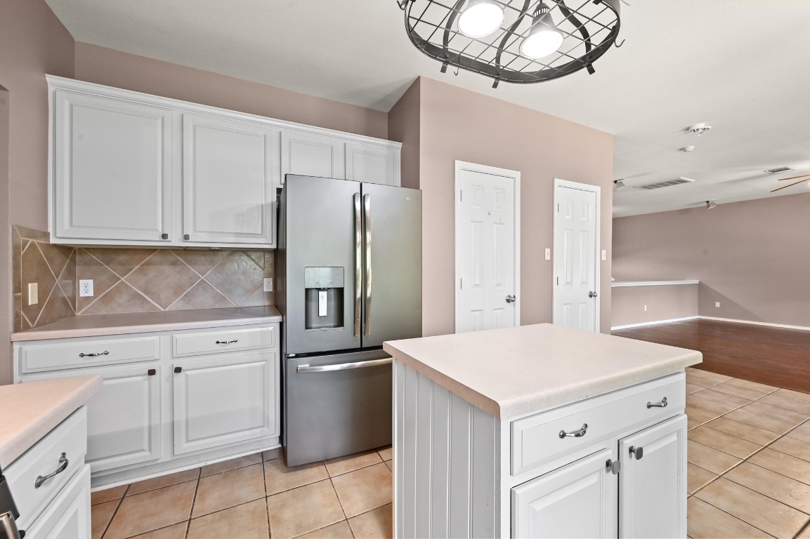 964 Hometown Parkway Kyle, TX 78640 - Photo 15 of 38 a kitchen with cabinets and stainless steel appliances
