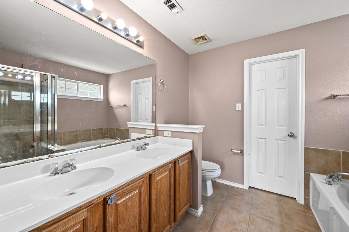 964 Hometown Parkway Kyle, TX 78640 - Photo 21 of 38 a bathroom with a sink double vanity and a toilet