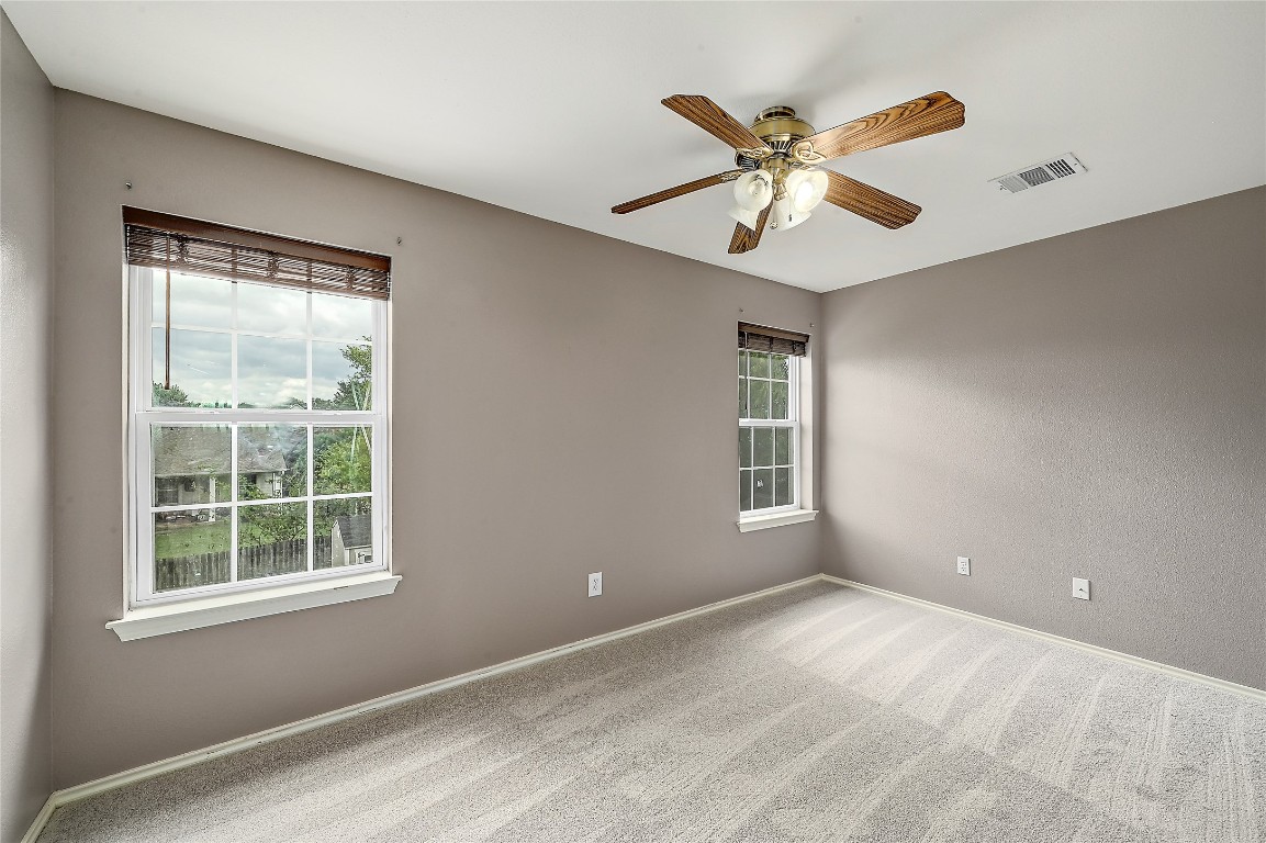 964 Hometown Parkway Kyle, TX 78640 - Photo 24 of 38 an empty room with window and ceiling fan