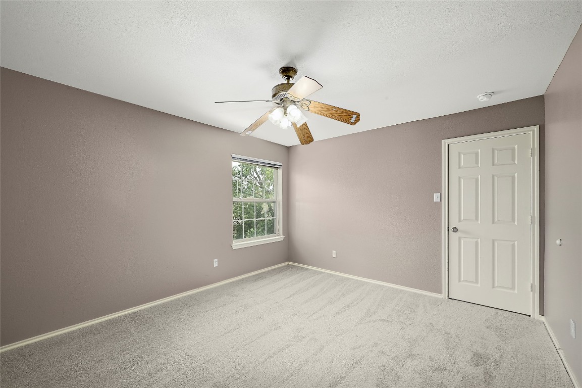 964 Hometown Parkway Kyle, TX 78640 - Photo 27 of 38 wooden floor in an empty room with a window