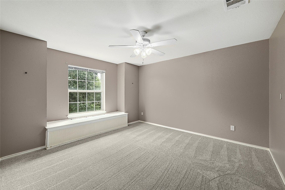 964 Hometown Parkway Kyle, TX 78640 - Photo 28 of 38 an empty room with a window and a fan