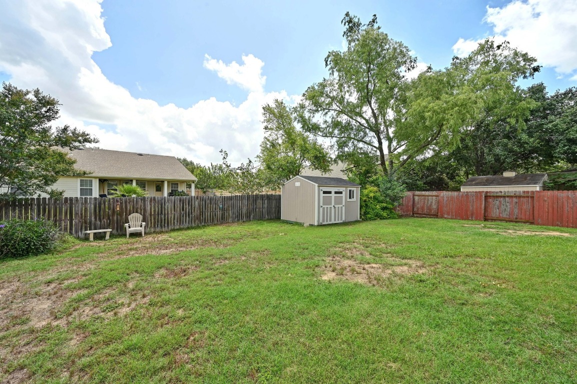 964 Hometown Parkway Kyle, TX 78640 - Photo 33 of 38 a backyard of a house with table and chairs