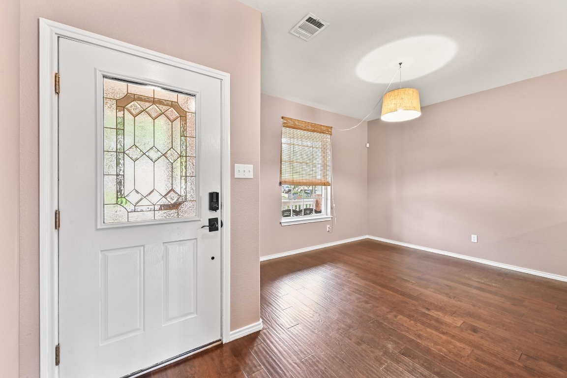964 Hometown Parkway Kyle, TX 78640 - Photo 5 of 38 an empty room with wooden floor and windows