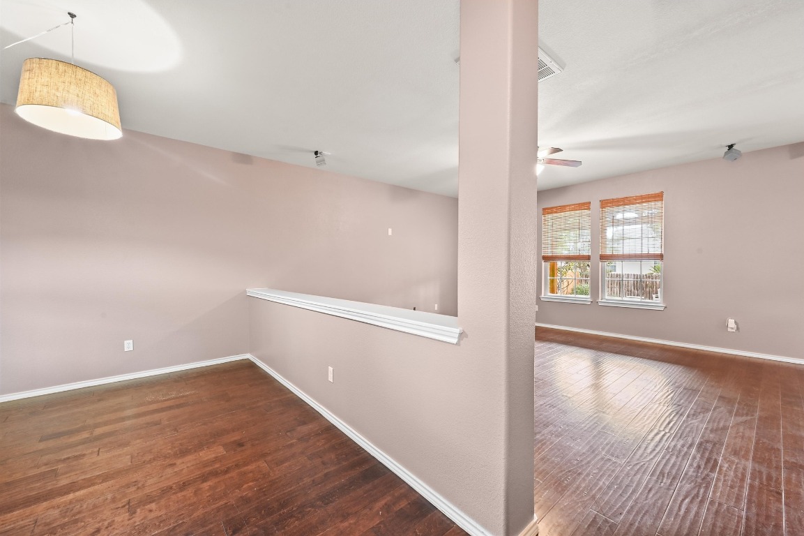 964 Hometown Parkway Kyle, TX 78640 - Photo 6 of 38 an empty room with wooden floor and windows