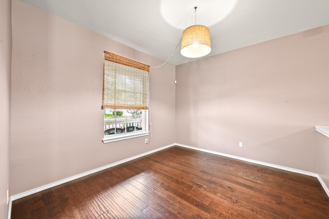 964 Hometown Parkway Kyle, TX 78640 - Photo 7 of 38 an empty room with wooden floor and windows