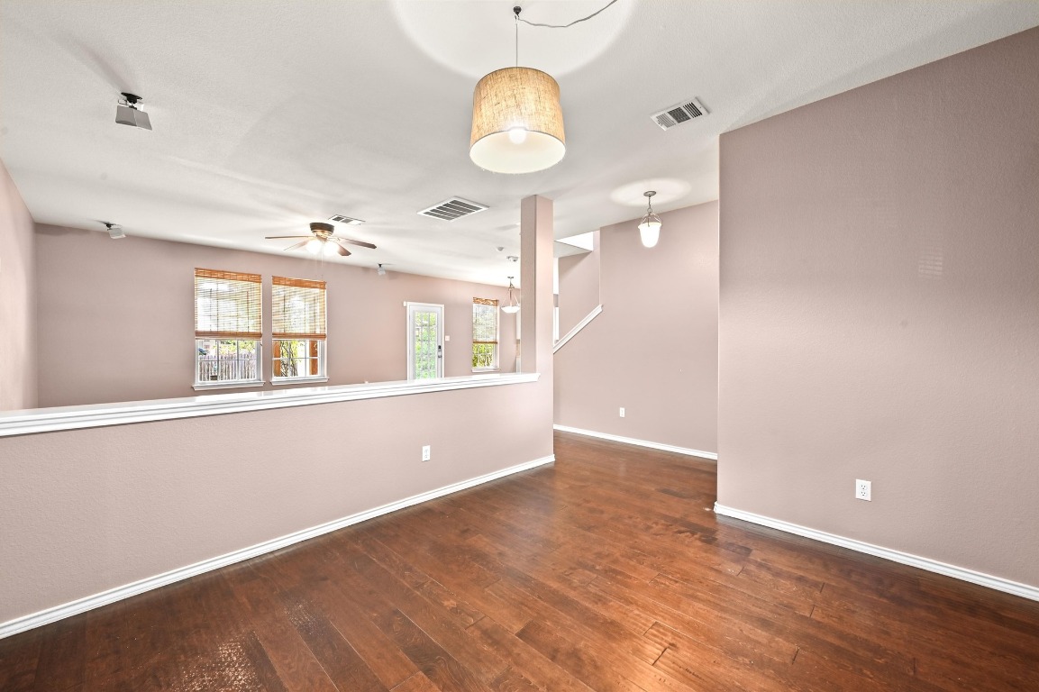 964 Hometown Parkway Kyle, TX 78640 - Photo 8 of 38 a view of an empty room with window and wooden floor