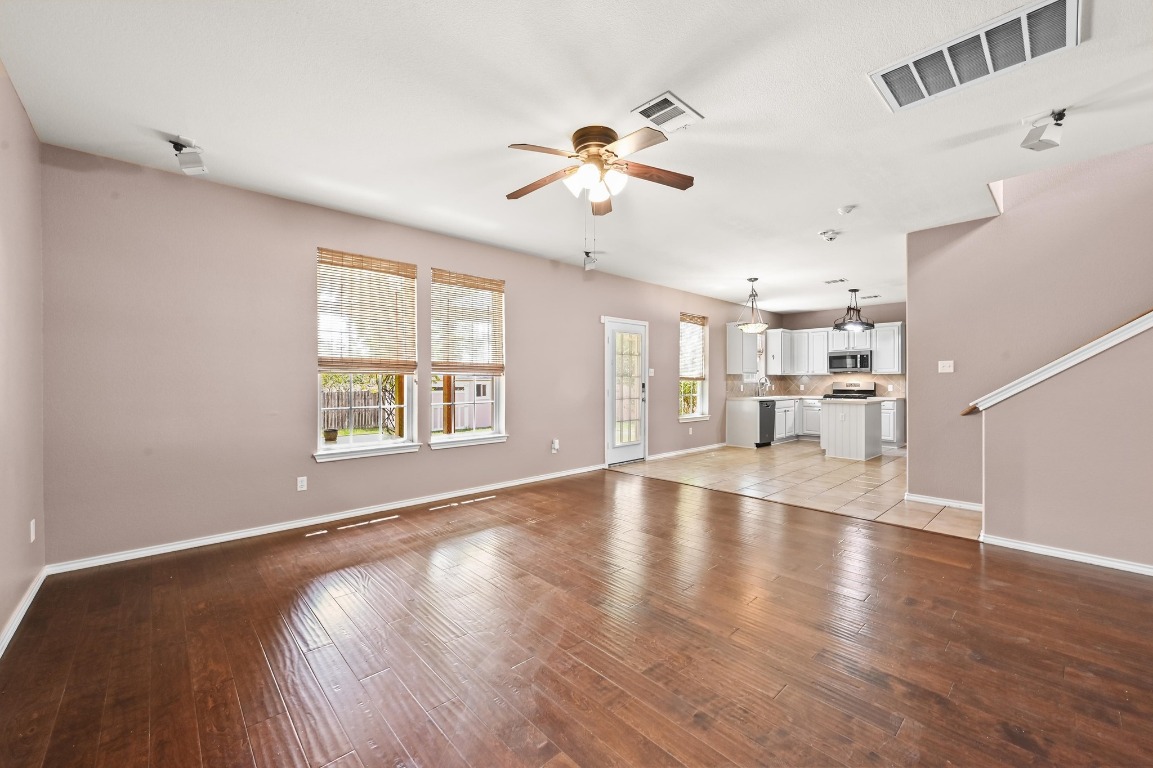 964 Hometown Parkway Kyle, TX 78640 - Photo 10 of 38 a view of an empty room with a window and wooden floor