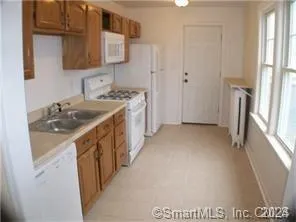 a kitchen with a sink stove and a refrigerator