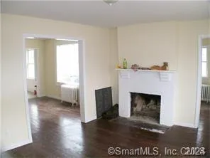 a view of a livingroom with a fireplace and window