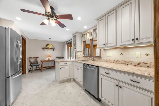 a kitchen with granite countertop cabinets stainless steel appliances and a window