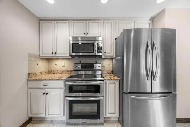a kitchen with stainless steel appliances a refrigerator stove and microwave