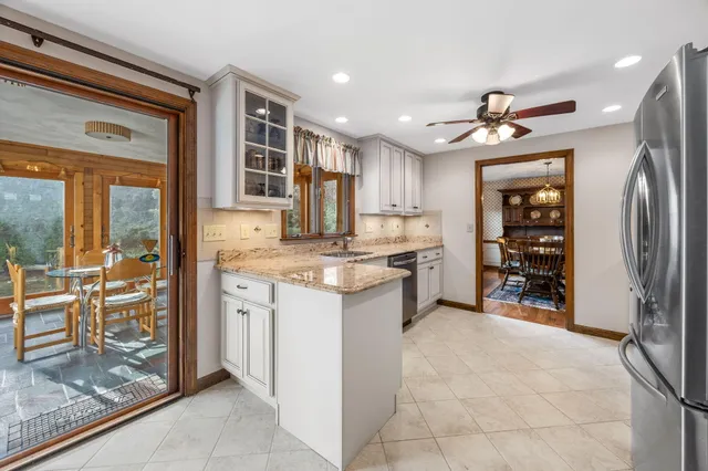 a kitchen with stainless steel appliances granite countertop a refrigerator and a sink