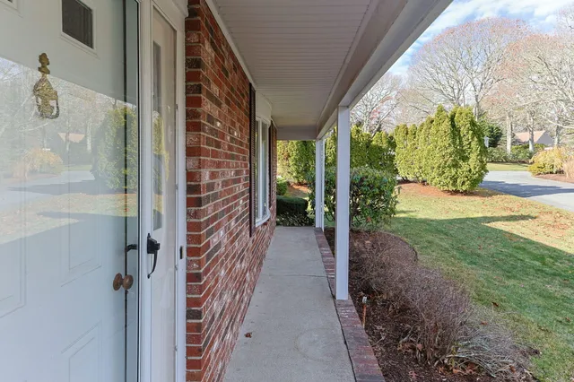 a view of a pathway of a house with backyard and garden