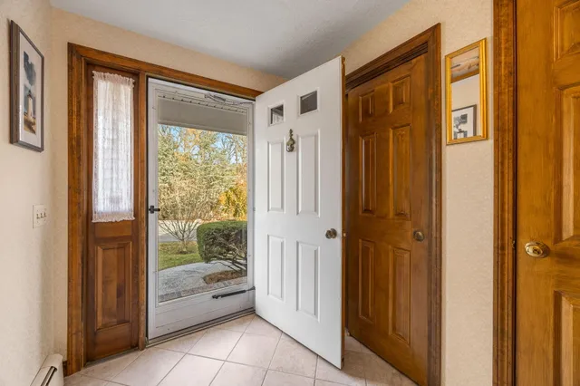 a bathroom with a tub shower and window