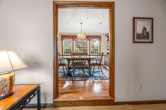 a dining room with furniture and wooden floor