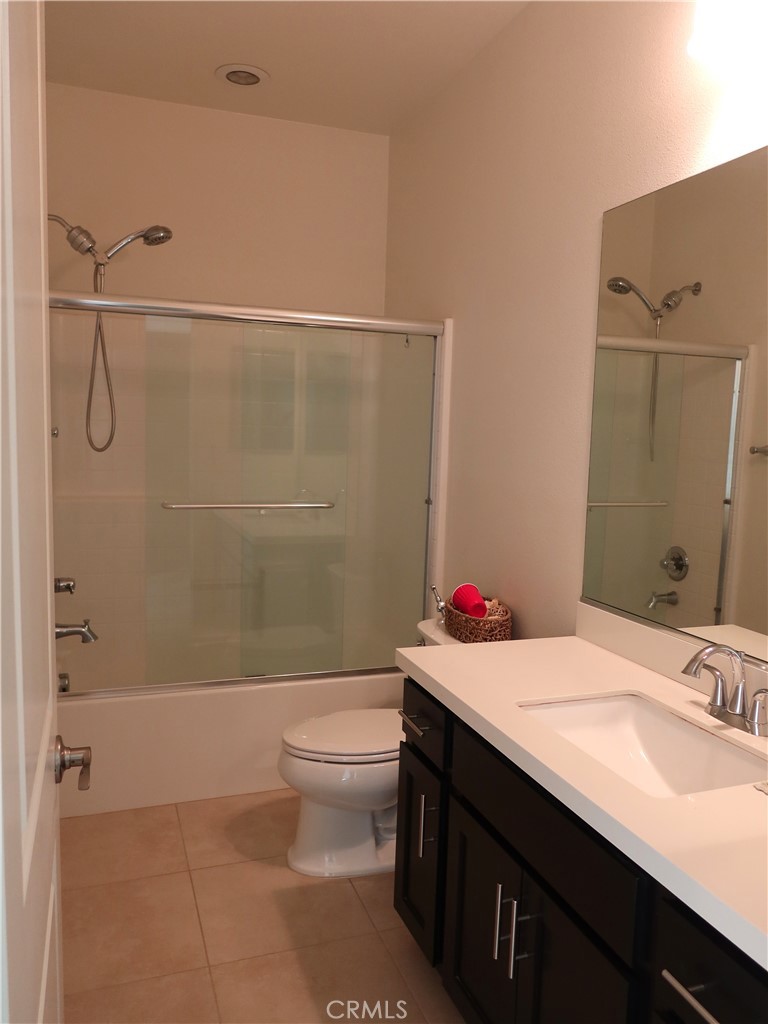 9498 Azusa Court Riverside, CA 92508 - Photo 18 of 27 a bathroom with a sink and a mirror