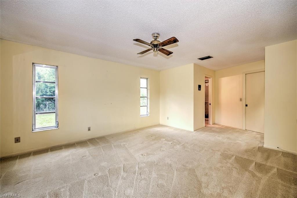 5960 Copper Leaf Lane Naples, FL 34116 - Photo 13 of 37 a view of a room with a window and a ceiling fan
