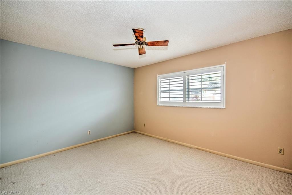 5960 Copper Leaf Lane Naples, FL 34116 - Photo 15 of 37 an empty room with windows