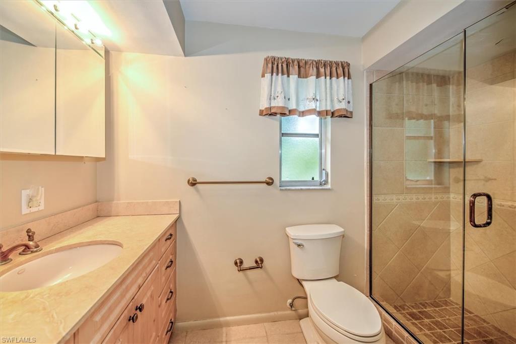 5960 Copper Leaf Lane Naples, FL 34116 - Photo 17 of 37 a bathroom with a sink a toilet and shower