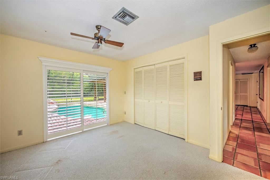 5960 Copper Leaf Lane Naples, FL 34116 - Photo 18 of 37 an empty room with windows