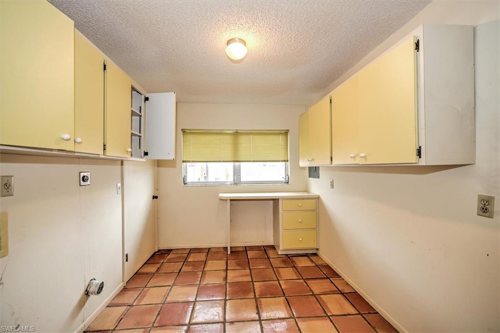 5960 Copper Leaf Lane Naples, FL 34116 - Photo 20 of 37 a kitchen with a sink a refrigerator and window