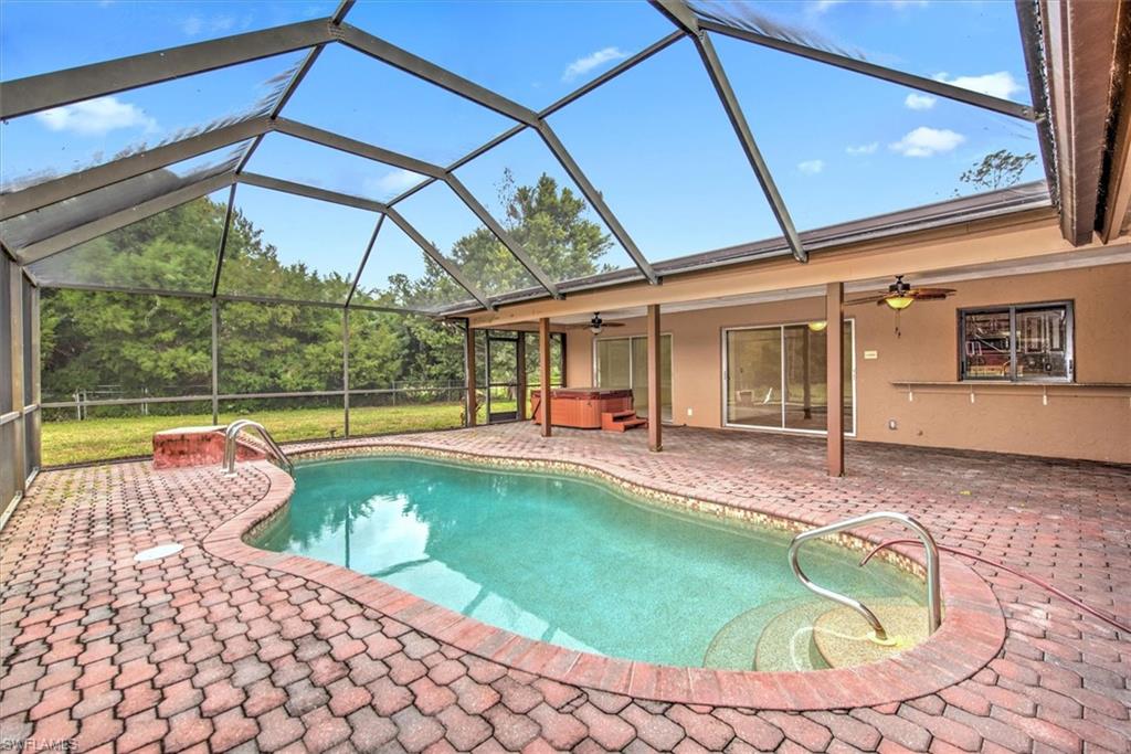 5960 Copper Leaf Lane Naples, FL 34116 - Photo 21 of 37 a swimming pool with outdoor seating