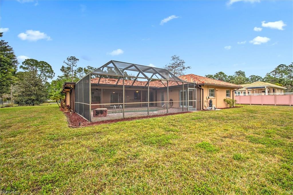 5960 Copper Leaf Lane Naples, FL 34116 - Photo 26 of 37 a view of a house with a big yard and potted plants
