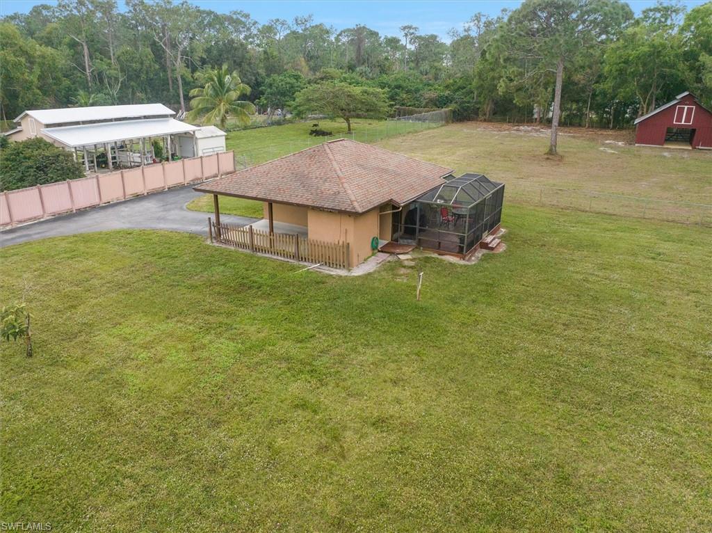 5960 Copper Leaf Lane Naples, FL 34116 - Photo 27 of 37 an aerial view of a house with swimming pool garden view and trees