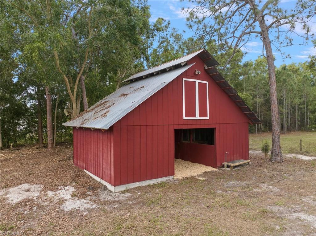 5960 Copper Leaf Lane Naples, FL 34116 - Photo 30 of 37 a view of barn with a small yard and large trees