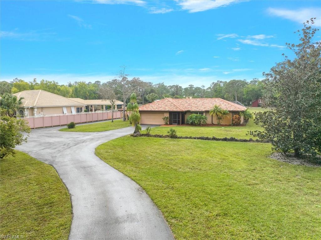 5960 Copper Leaf Lane Naples, FL 34116 - Photo 3 of 37 a view of a house with a big yard