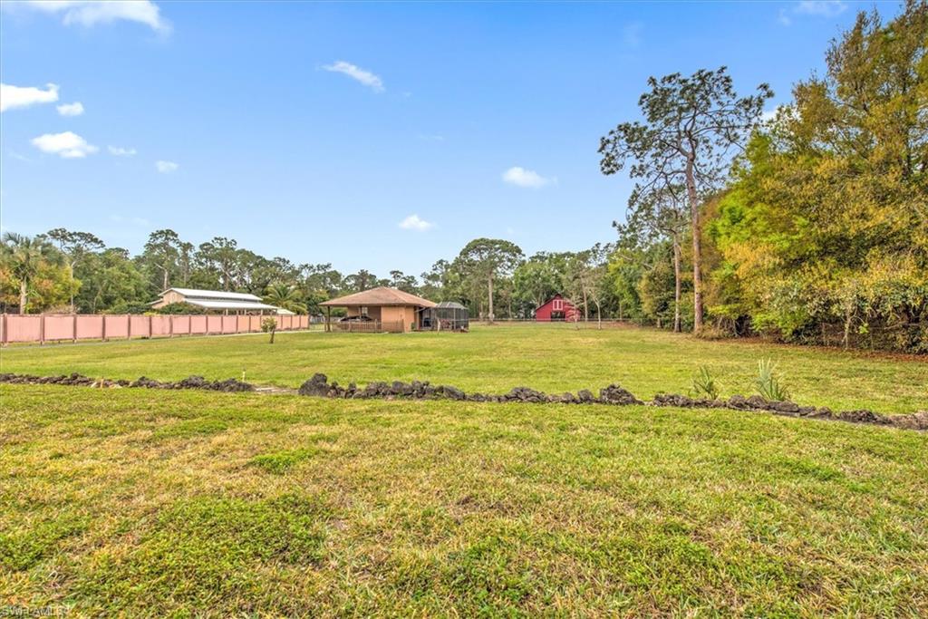 5960 Copper Leaf Lane Naples, FL 34116 - Photo 36 of 37 a view of a field with an trees
