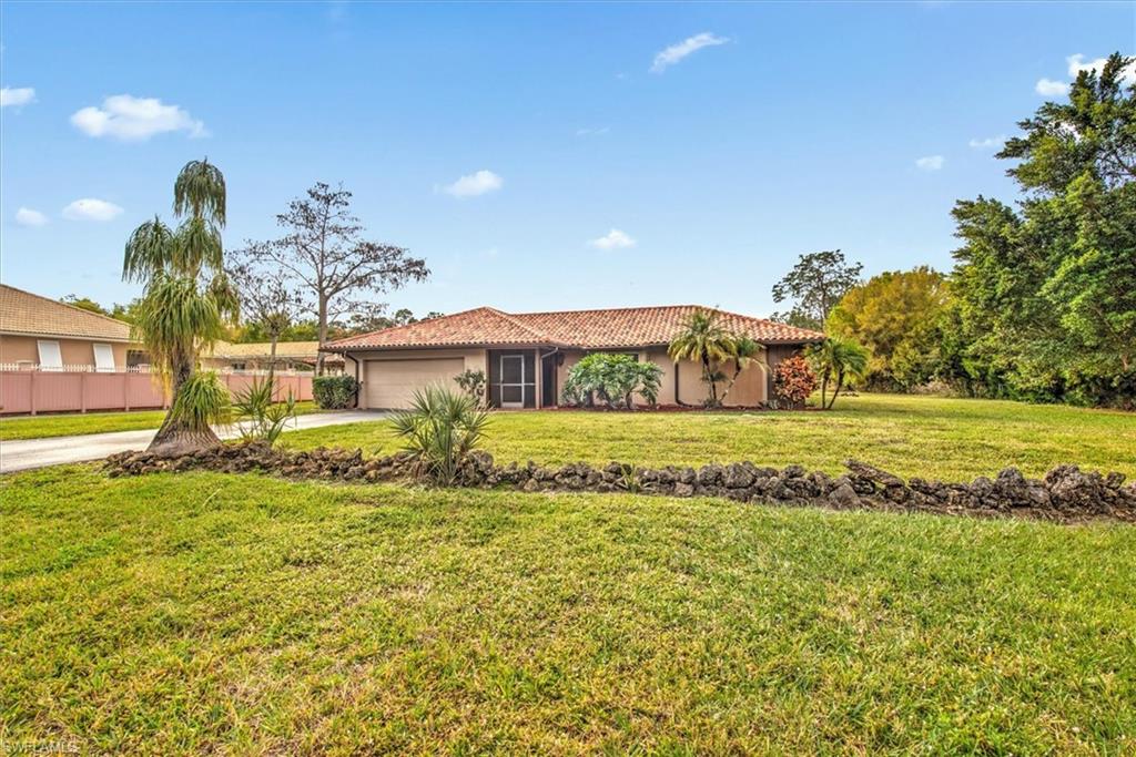 5960 Copper Leaf Lane Naples, FL 34116 - Photo 5 of 37 a front view of a house with a yard