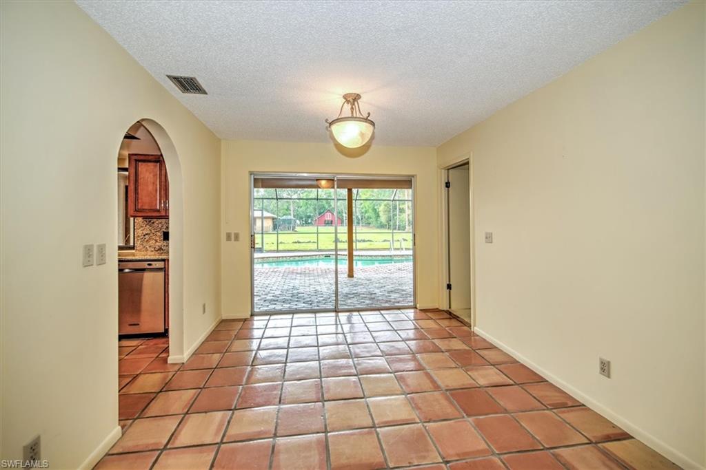 5960 Copper Leaf Lane Naples, FL 34116 - Photo 8 of 37 a view of a livingroom with wooden floor and a window