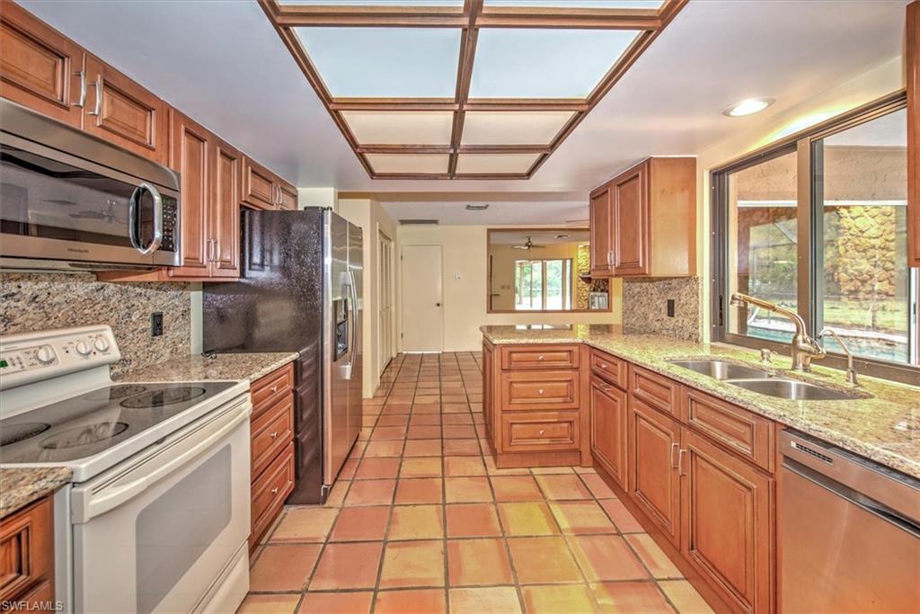 5960 Copper Leaf Lane Naples, FL 34116 - Photo 9 of 37 a large kitchen with a large window