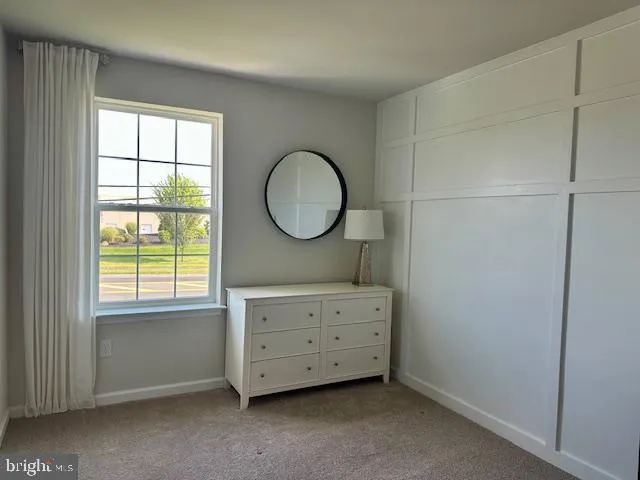 a room with a dresser and a window